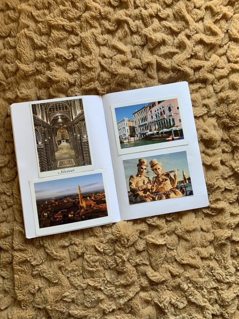Open photo album with travel memories from Italy, featuring views of Siena and Venice.