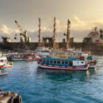 white and blue ship on sea water